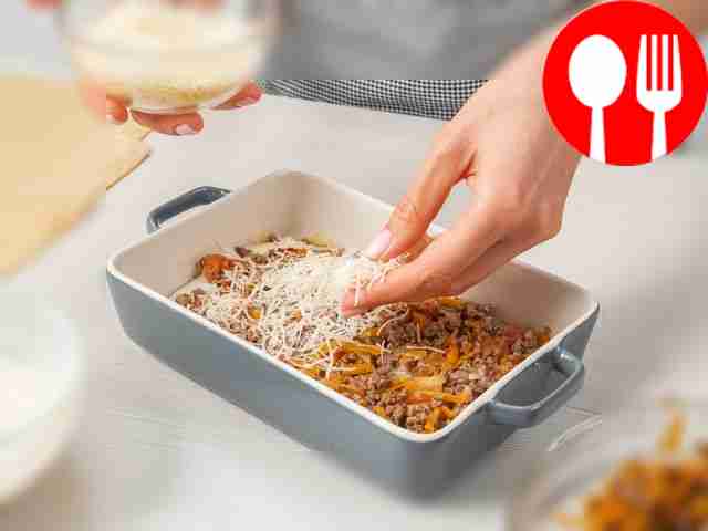 Bake the lasagna. Grease a baking sheet with...