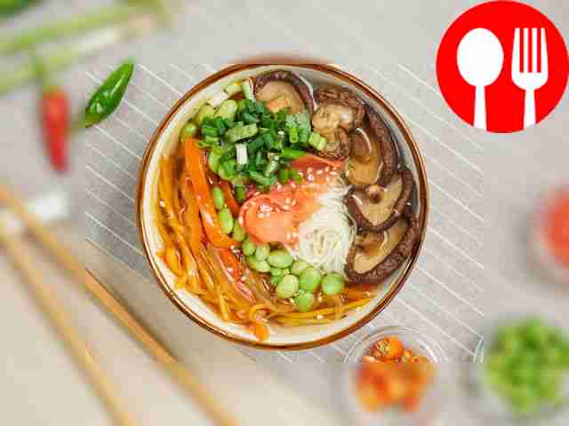 Serve the ramen hot, sprinkled with chopped...