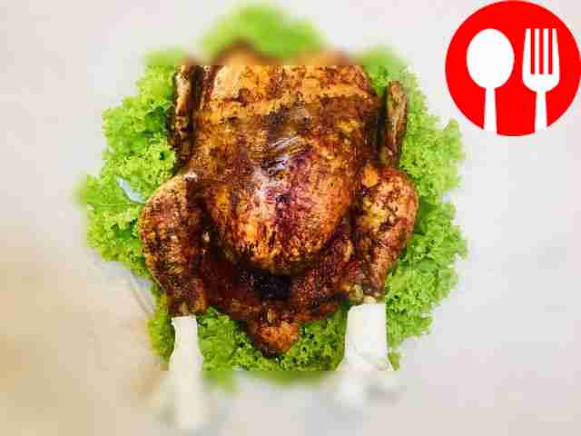 Serve the baked chicken after cutting it into...