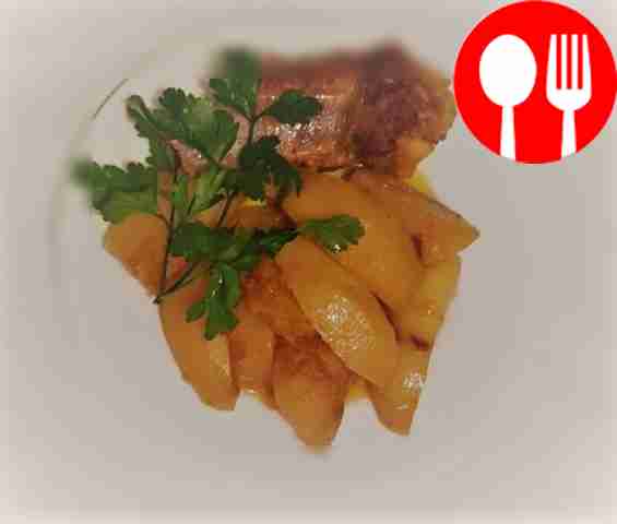 Golden potatoes with ribs in a slow cooker