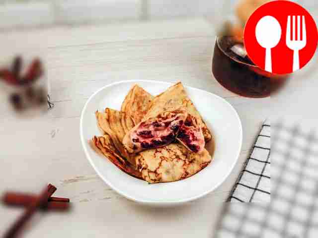 Pancakes with cherries and sour cream