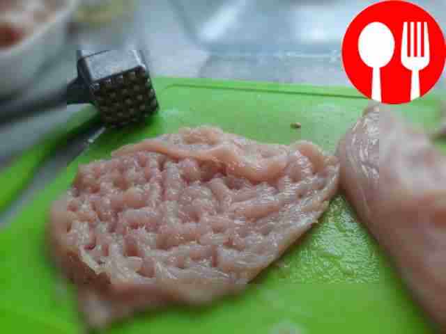 Beat the chicken fillet, place in a baking...