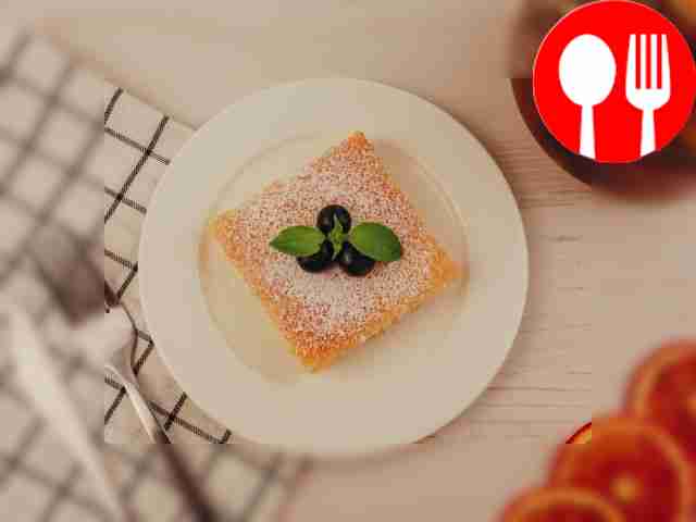 Serve the sponge cake garnished with powdered...