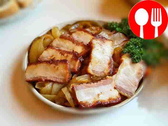 Nourishing lard with onions in a frying pan