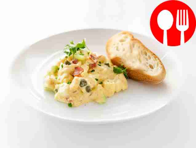 Egg salad with crispy bacon, celery and curry