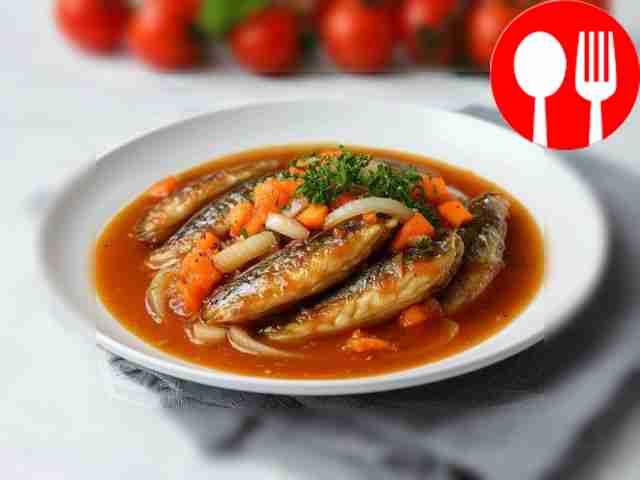 Stewed sprat in tomato sauce in a frying pan with carrots