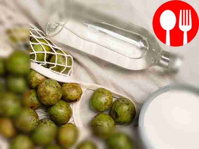 Wash and cut the green nuts in half. Prepare a...