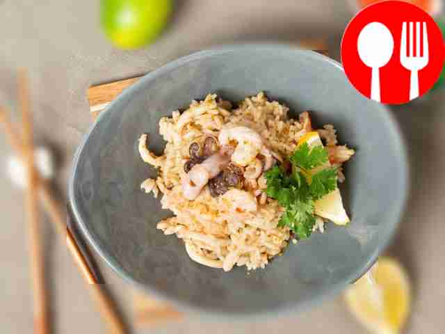 Place seafood fried rice on serving plates,...