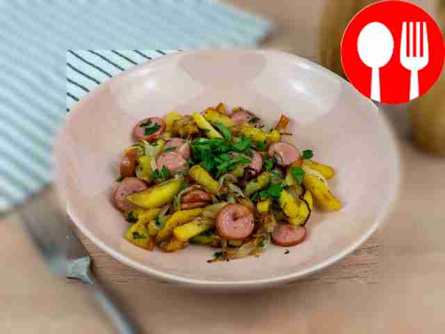 Potatoes with sausages in a frying pan