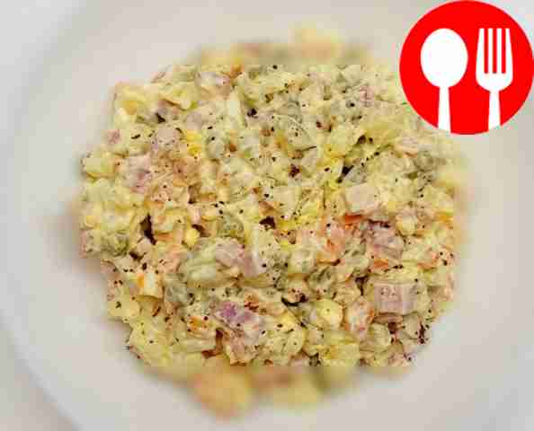 Place the salad on a serving plate using a...