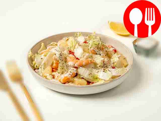 Salad with pineapple, shrimp, Chinese cabbage and pomegranate