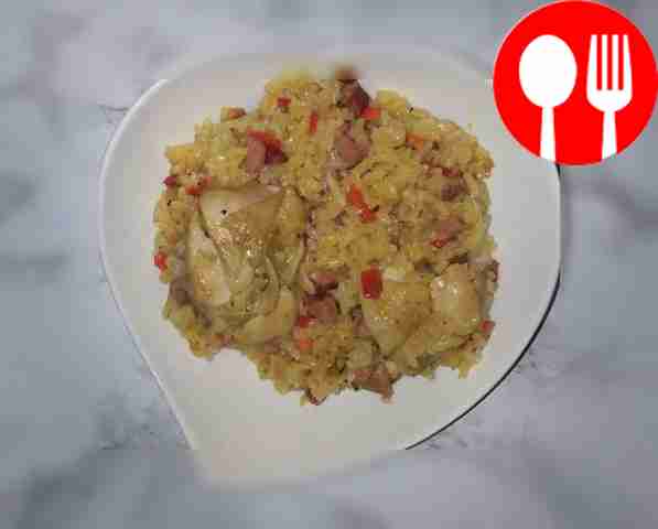 Chicken pilaf with sausage in a frying pan