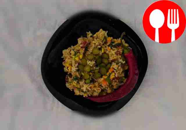Serve hot fried rice with vegetables and eggs,...