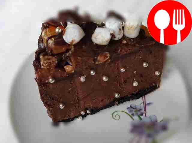 Bright chocolate cake with fruits and marshmallows