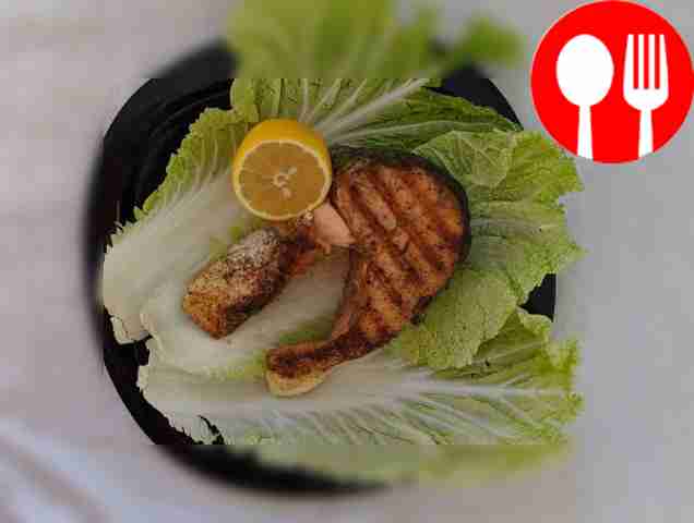 Salmon steak with spices in a frying pan