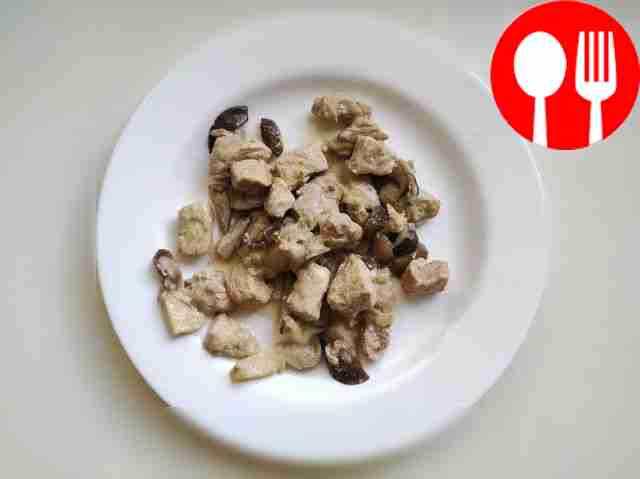 Meat with oyster mushrooms in a frying pan