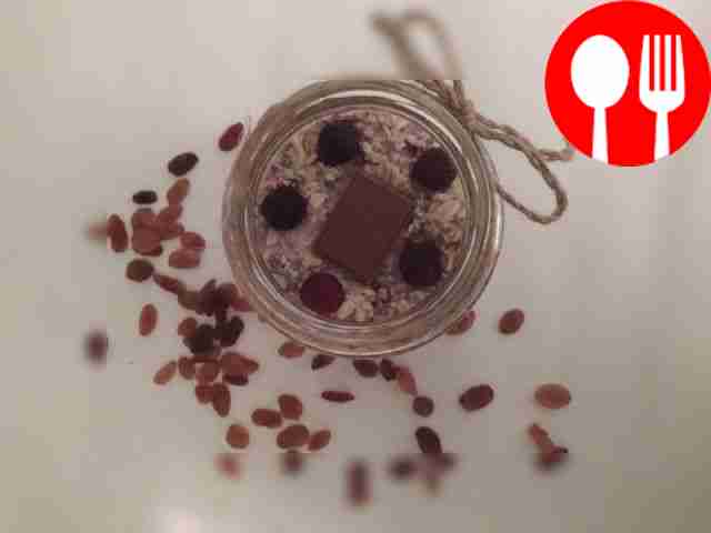 Lazy oatmeal in a jar with chia seeds, berries and chocolate