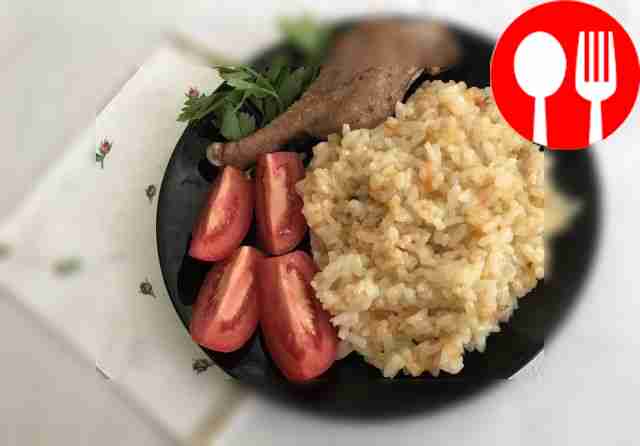 Duck fried in a pan with rice