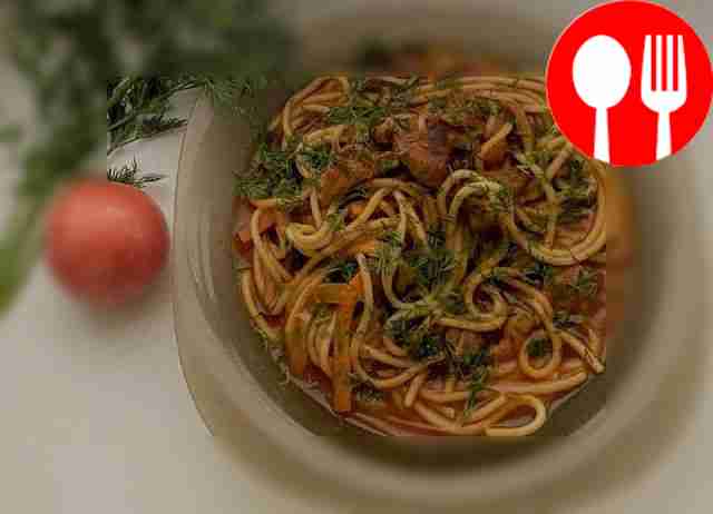 Classic pork in tomato sauce with spaghetti and vegetables