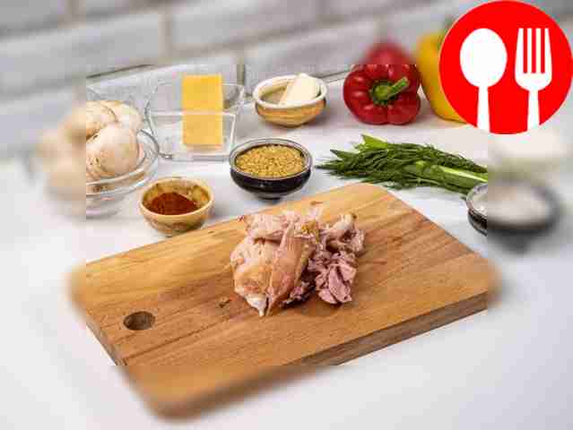 Remove bones and skin from smoked chicken thigh.
