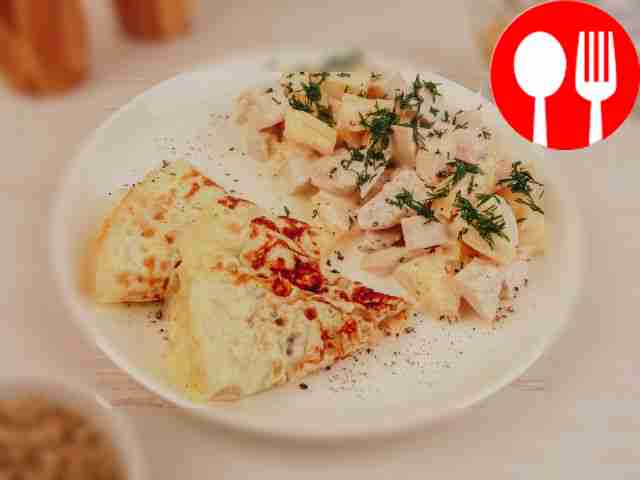 Salad with egg pancakes, chicken and pineapple