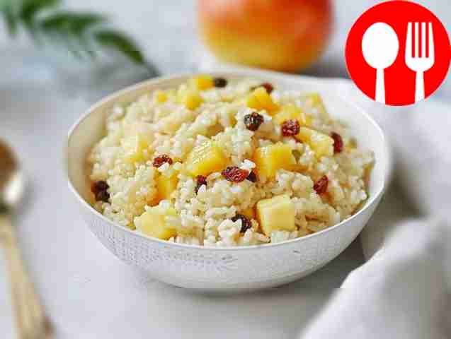 Boiled rice porridge on water with raisins and apples