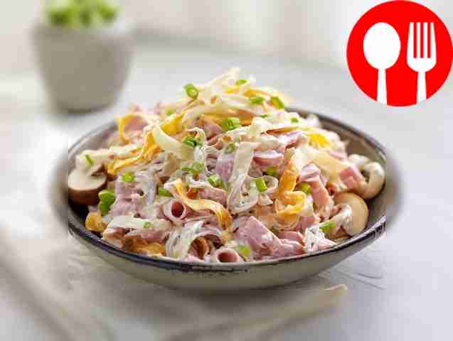 Hearty salad with ham, cheese and pancakes