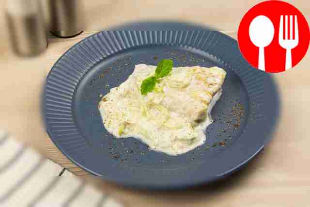 Pike perch in cream and wine in a frying pan