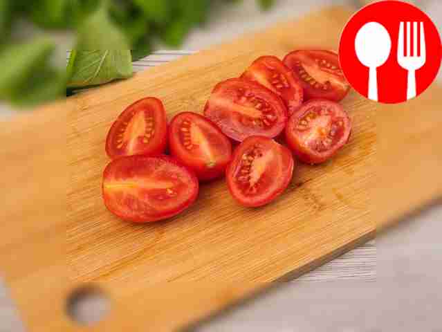 Cut cherry tomatoes in half.