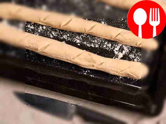Bake baguettes. Sprinkle a baking tray with...