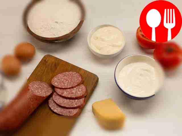 Cut the sausage into cubes and slice the...