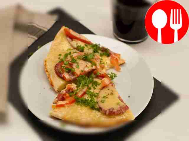 Cut the finished pizza into portions and serve.