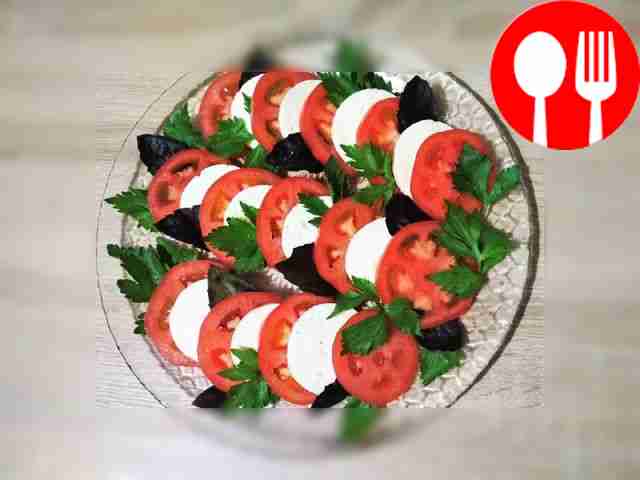 Aromatic appetizer “Caprese” made from tomato and cheese