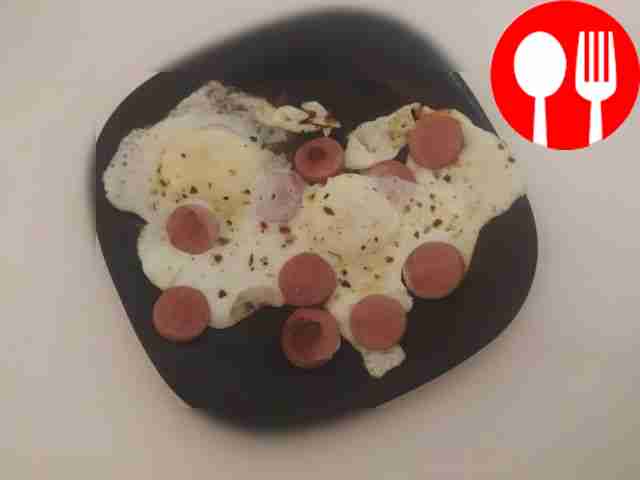 Classic scrambled eggs for breakfast with sausages