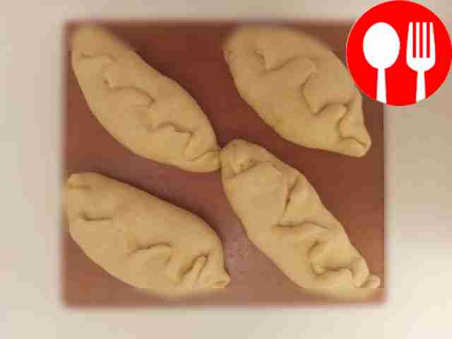 When the dough has risen, place it on the work...