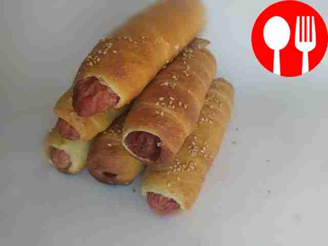 Homemade sausages in sesame dough