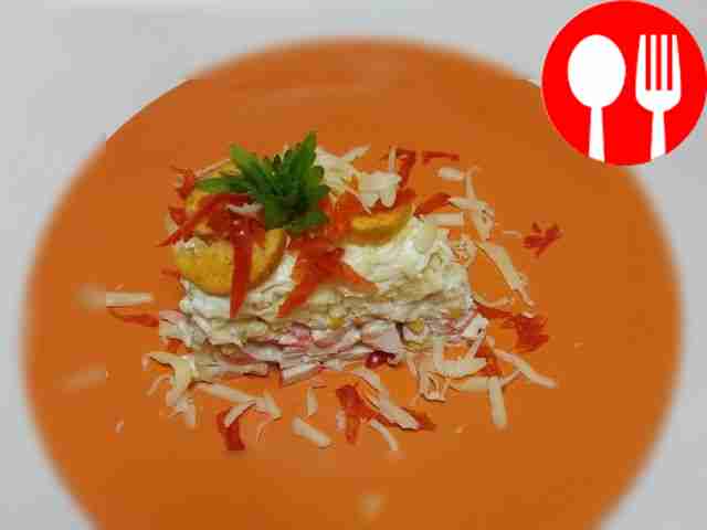 Layered salad of crab sticks, corn and cheese