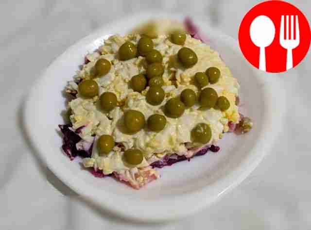 Homemade salad “Salmon under a fur coat” with melted cheese