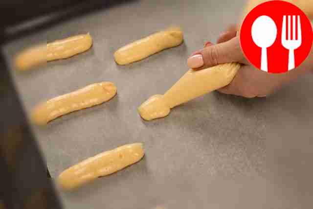 Transfer the dough into a piping bag. Line a...