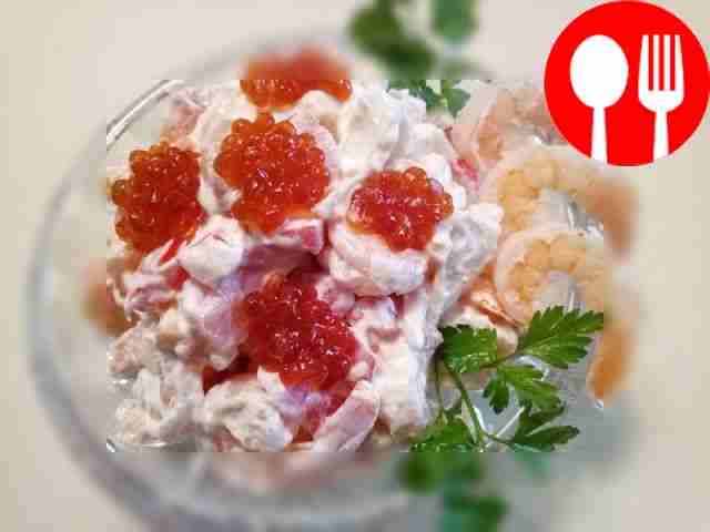 Delicious salad with caviar, shrimp, salmon and squid