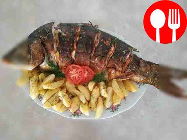 Juicy carp baked in the oven with potatoes