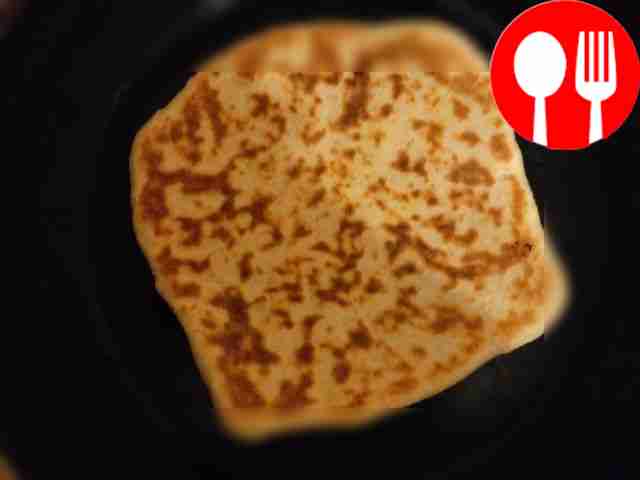 Grease each finished flatbread with a piece of butter.