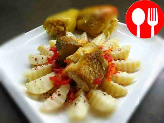 Juicy hake with vegetables, stewed in a frying pan