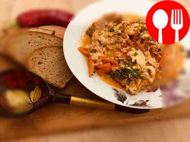 Tender pollock in sour cream sauce with vegetables