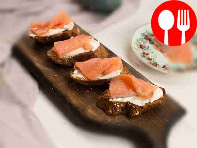 Spread the baguette with curd cheese and lay...