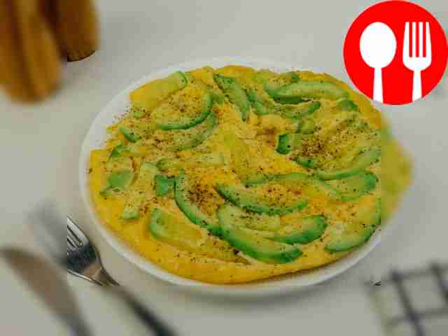 Decorate the omelette with fresh herbs and...
