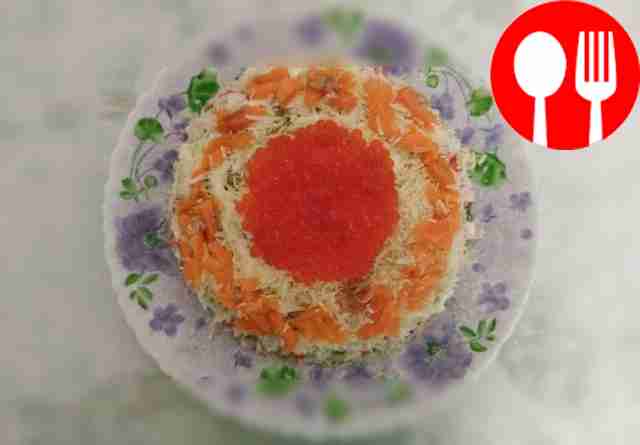 Appetizing salad of crab sticks with avocado and red caviar