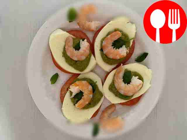 Unusual Caprese salad with king prawns and pesto sauce