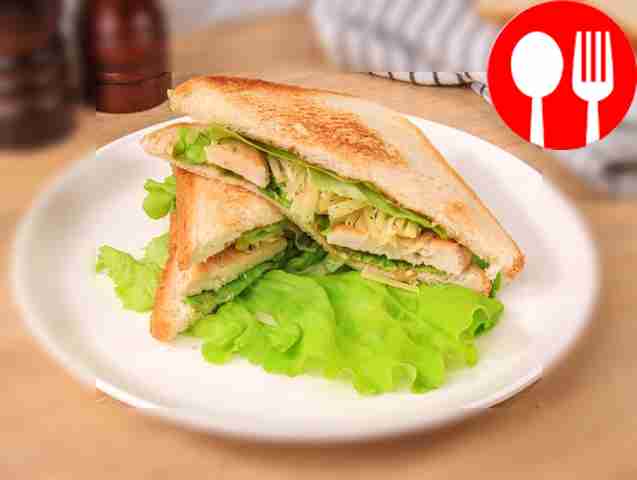 Sandwich with chicken fillet, iceberg lettuce, cheese and tomatoes