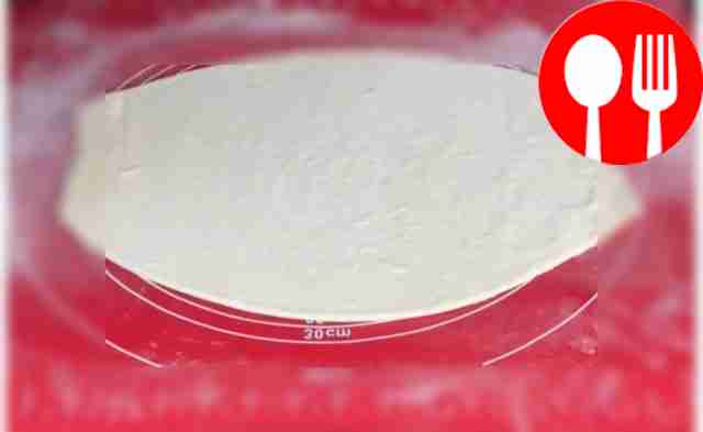 Grate the cheese and place it on the dough in...